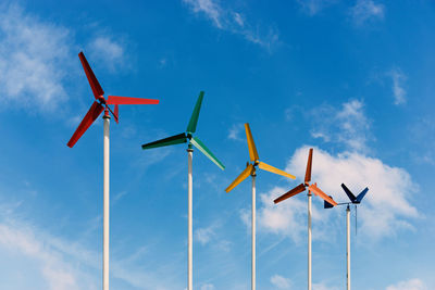 Low angle view of airplane flying against blue sky