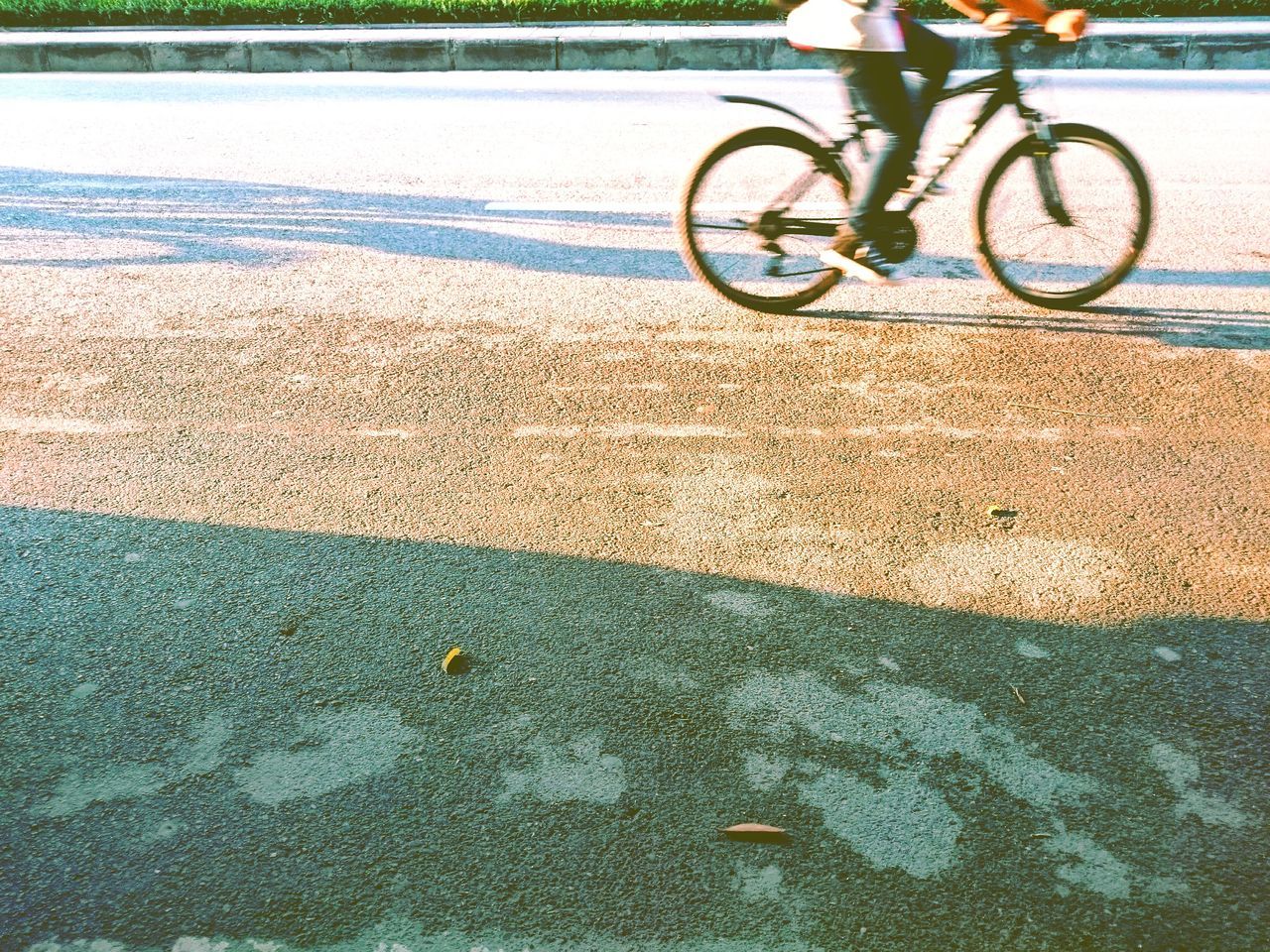 LOW SECTION OF PEOPLE RIDING BICYCLE ON STREET