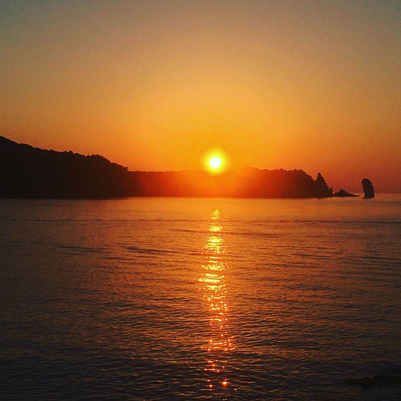 SCENIC VIEW OF SEA AGAINST ORANGE SKY DURING SUNSET