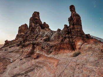 Low angle view of rock formation against sky