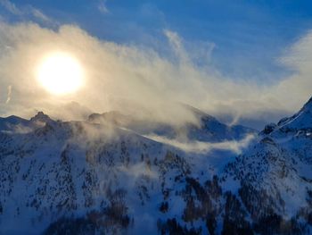 Scenic view of snowcapped mountains against sky