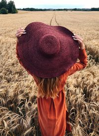 Rear view of woman wearing hat in farm