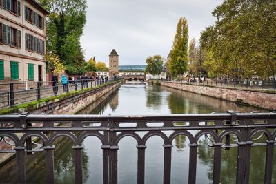 Bridge over river in city against sky