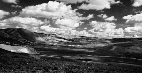 Scenic view of mountains against cloudy sky
