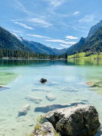 Scenic view of lake by mountain against sky