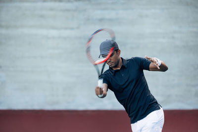 Boy playing tennis