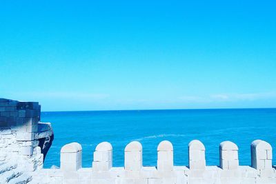 Scenic view of sea against clear blue sky