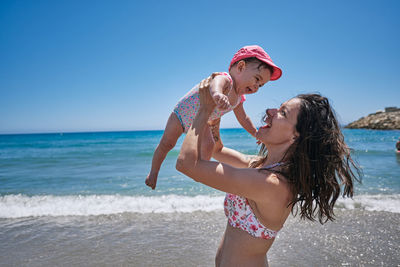 Full length of woman on beach against sky