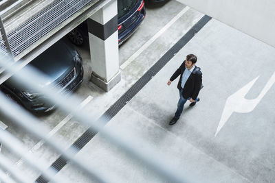 Businessman walking in parking garage