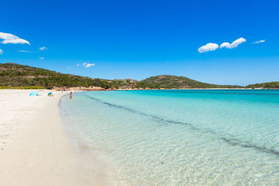 Scenic view of beach against blue sky