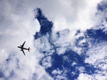 Low angle view of airplane flying in sky