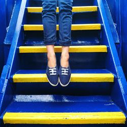 Low section of woman standing on tiled floor
