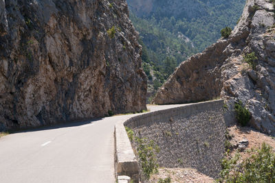 Road amidst rocks against mountains