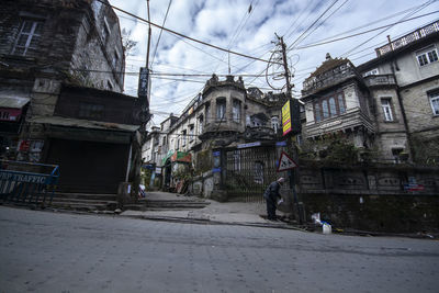 Street amidst buildings in city against sky