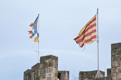 Low angle view of flag against buildings in city