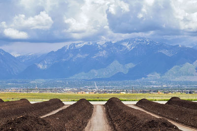 Rows of compost ready for sale with panoramic utah