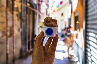 Close-up of hand holding ice cream cone