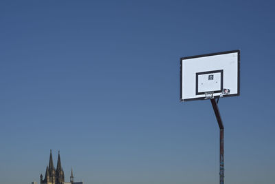 Low angle view of basketball hoop against clear sky