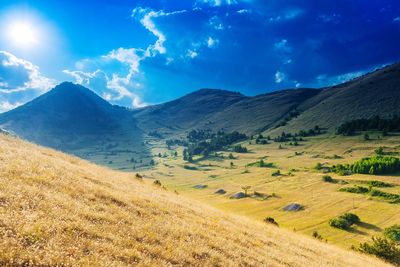 Scenic view of landscape and mountains against sky