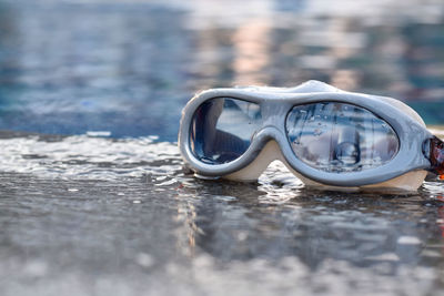 Close-up of goggles on swimming pool