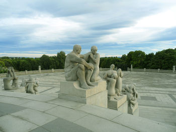 Statue of statues against cloudy sky