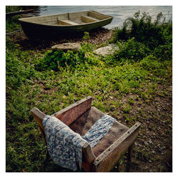 High angle view of abandoned chair on field