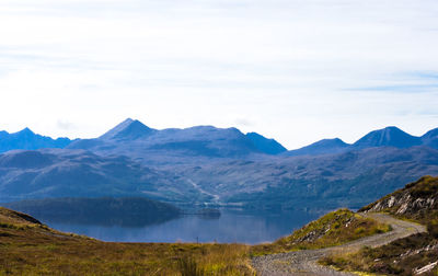 Scenic view of lake and mountains against sky