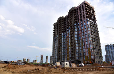 Low angle view of building at construction site against sky