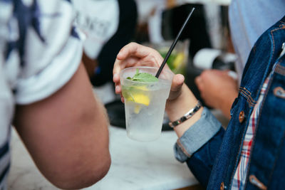 Cropped image of man holding beer glass