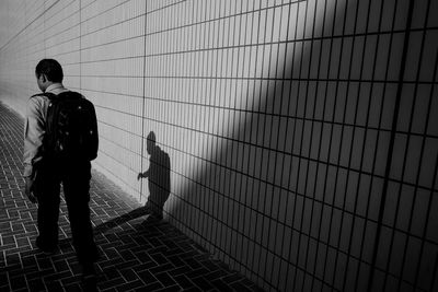 Full length of woman standing on sidewalk