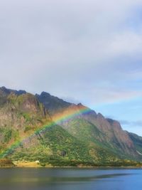 Scenic view of sea and mountains against sky