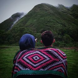 Rear view of couple on mountain road