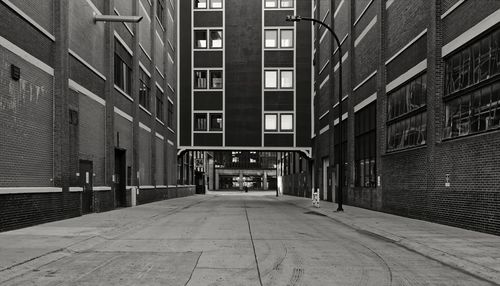 Empty alley amidst buildings in city