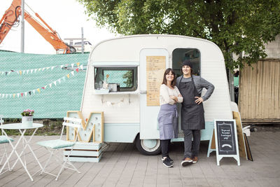 Full length portrait of young couple standing outdoors