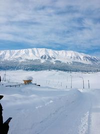 Scenic view of snow covered mountains against sky