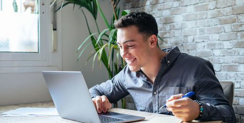 Young man using laptop at office