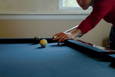 Man playing with pool on table at home