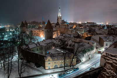 High angle view of illuminated buildings in city at night