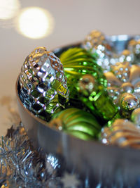 Close-up of christmas decorations in container on table