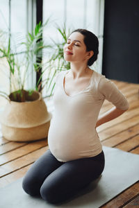 Young woman exercising in gym