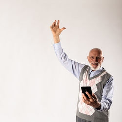 Man using mobile phone against white background