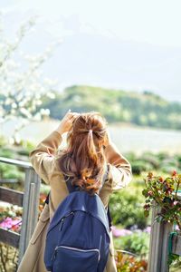 Rear view of woman looking at sea against sky