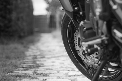 Close-up of bicycle parked on railroad track