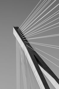 Low angle view of suspension bridge against clear sky