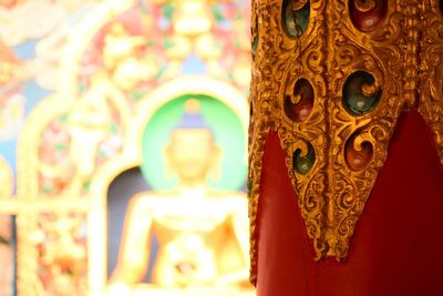 Close-up of buddha statue against building