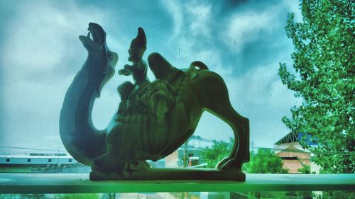 Low angle view of statue against sky