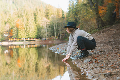 Rear view of man in lake by trees