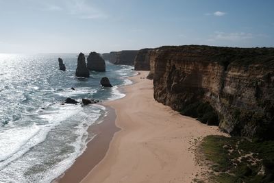 Rocks on beach against sky the twelve apostles along the great ocean road