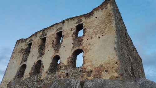 Low angle view of old ruin building against sky