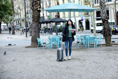 Full length of woman standing in city